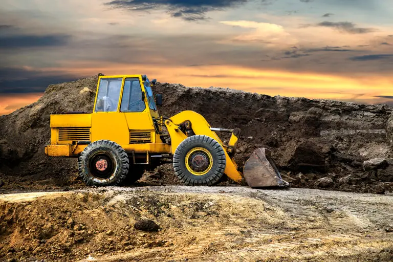 A bulldozer or loader moves the earth at the construction site a